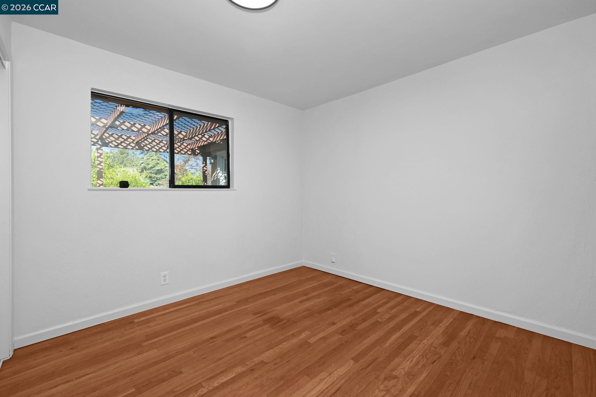 1921 Gilly Lane Concord, CA 94518 - Photo 13 of 29 a view of empty room with wooden floor