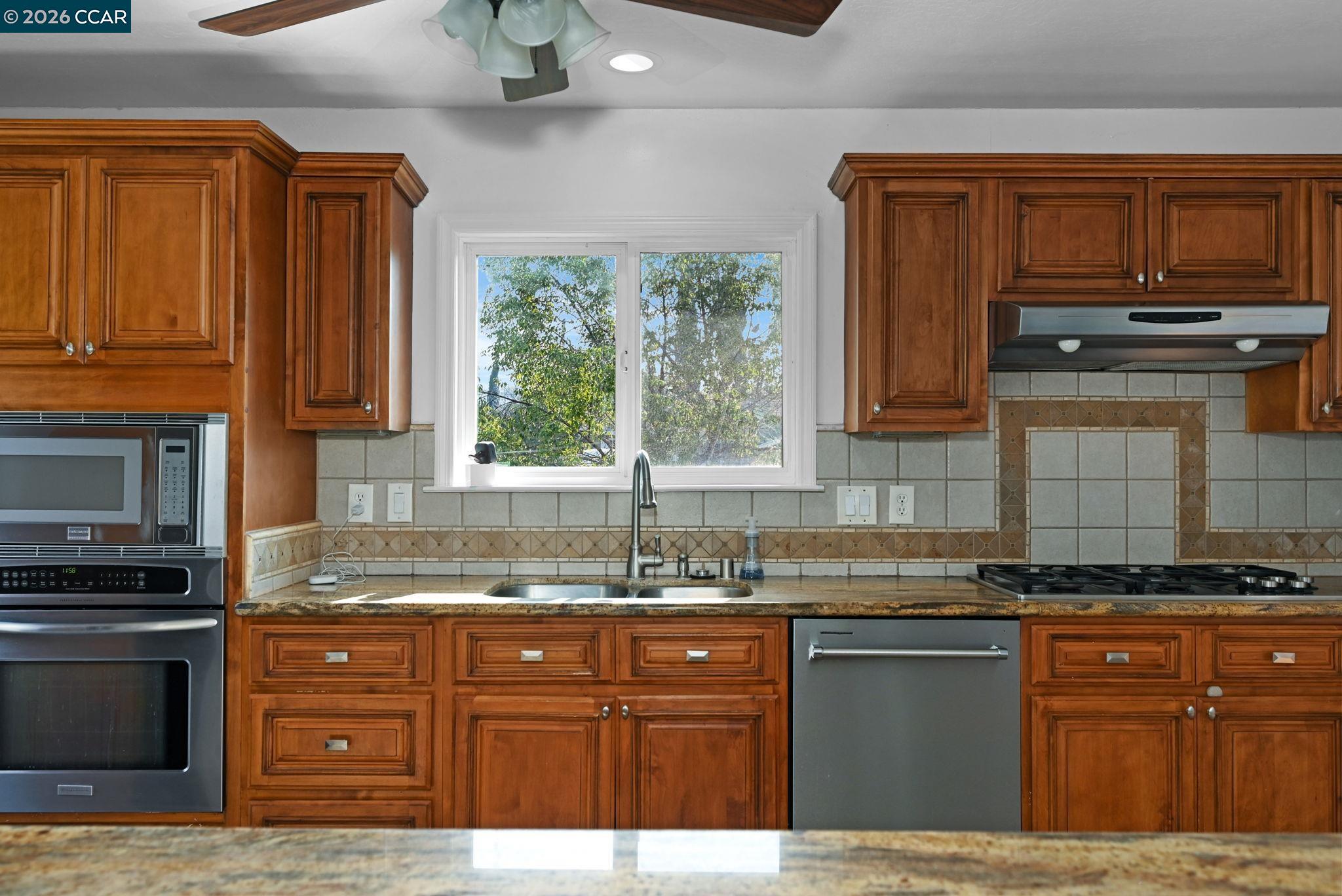 1921 Gilly Lane Concord, CA 94518 - Photo 5 of 29 a kitchen with granite countertop a stove sink and cabinets