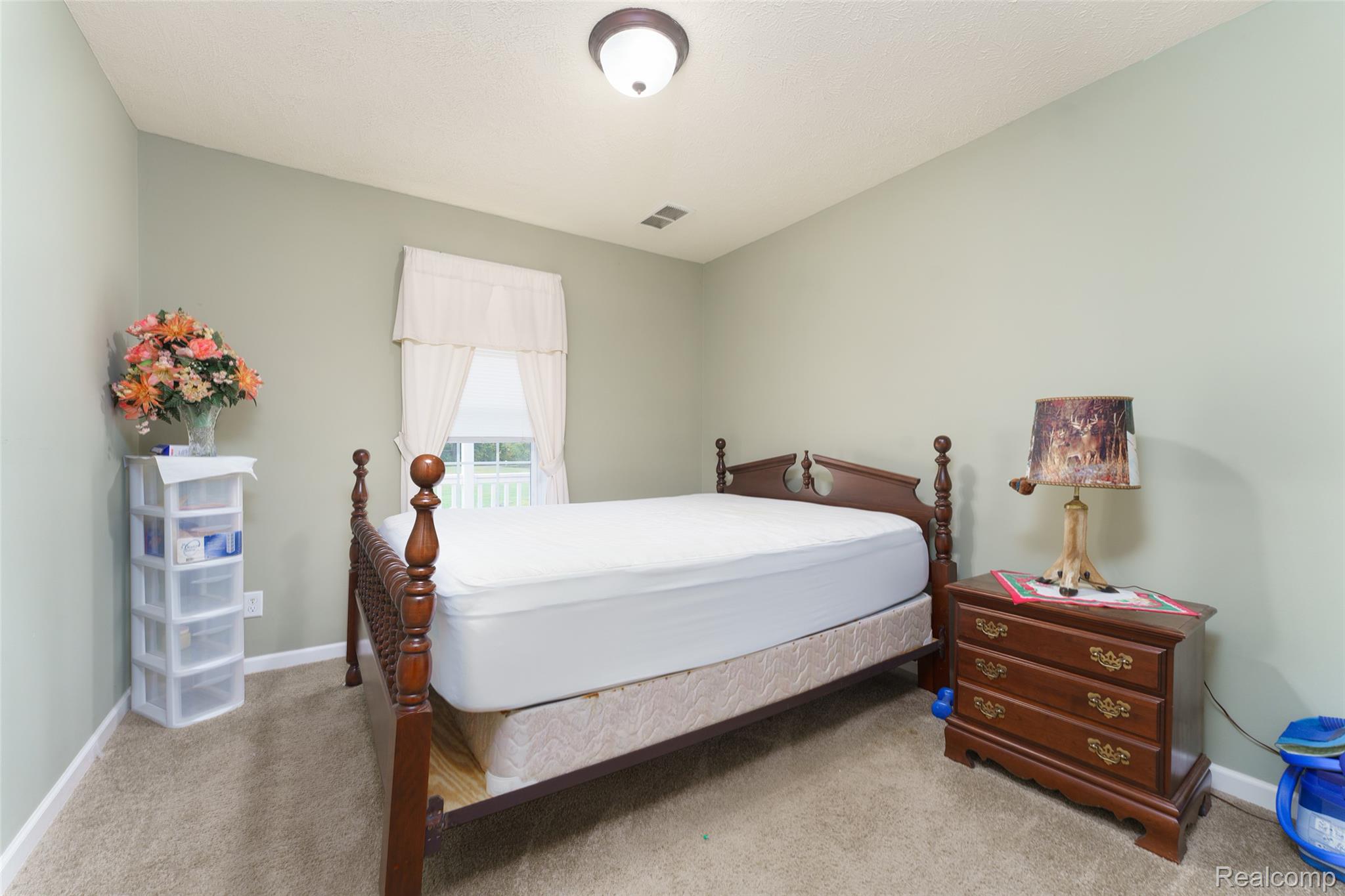 5601 West Lovejoy Road Byron, MI 48418 - Photo 11 of 40 Bedroom featuring light colored carpet and baseboards