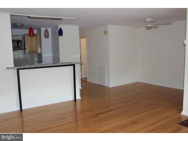 a view of a living room with wooden floor