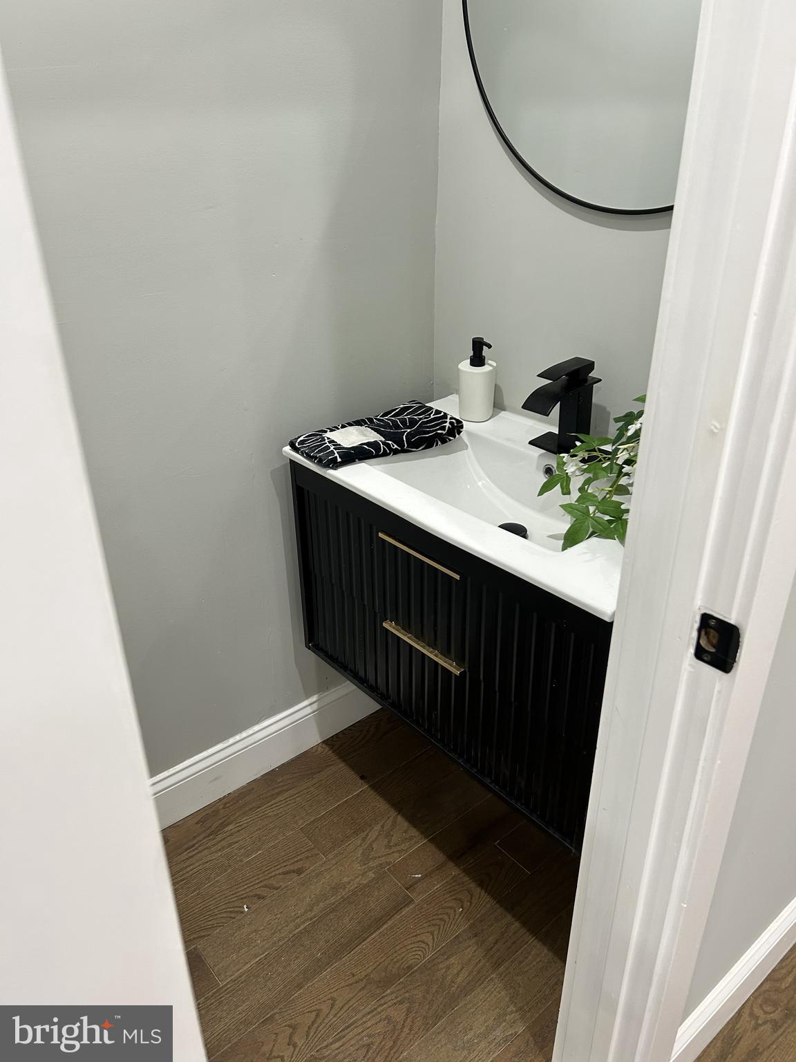 928 Perry Place Northeast Washington, DC 20017 - Photo 12 of 16 a bathroom with a sink and a mirror