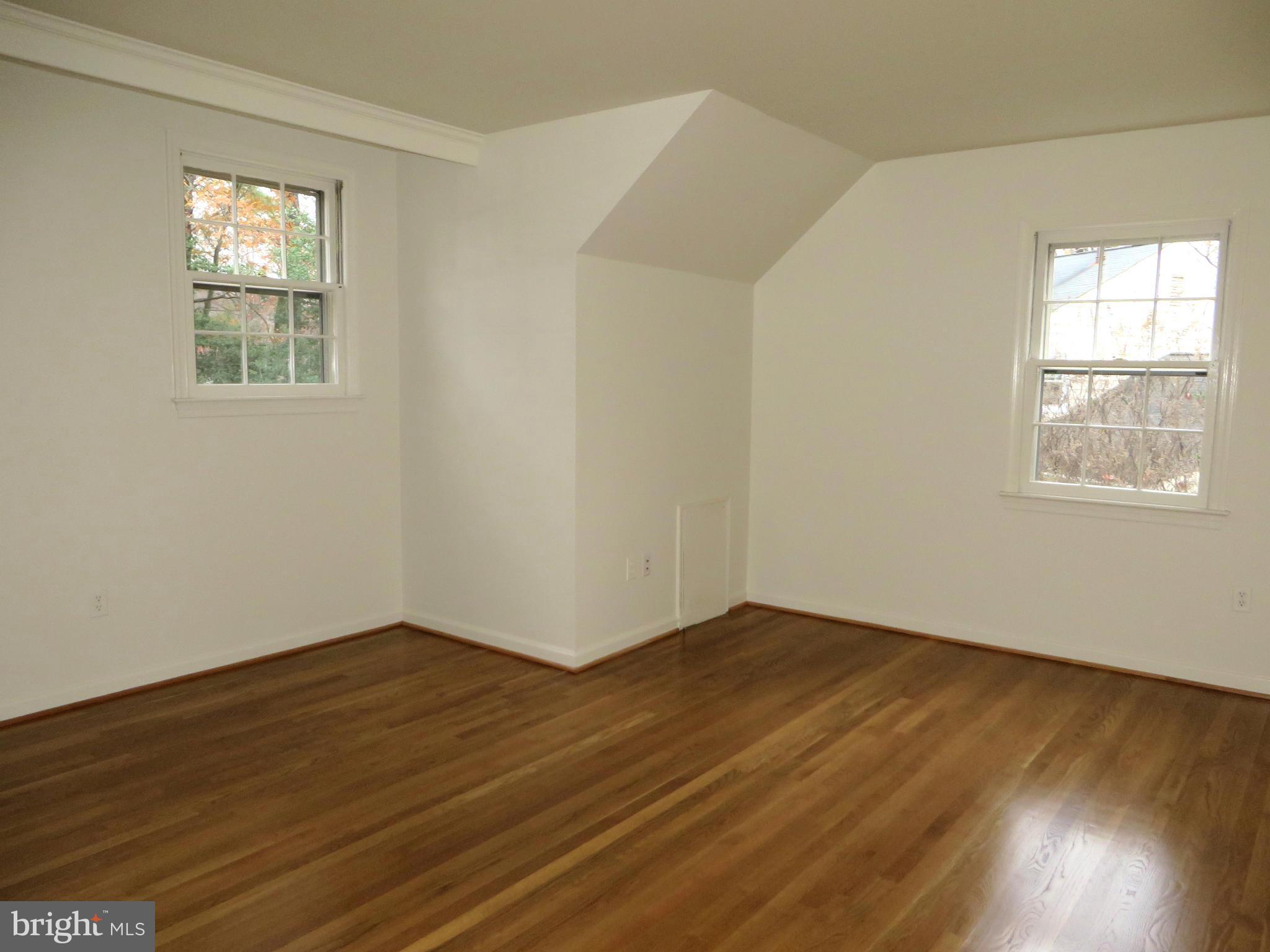 8425 Riverside Road Alexandria, VA 22308 - Photo 21 of 28 a view of an empty room with wooden floor and a window