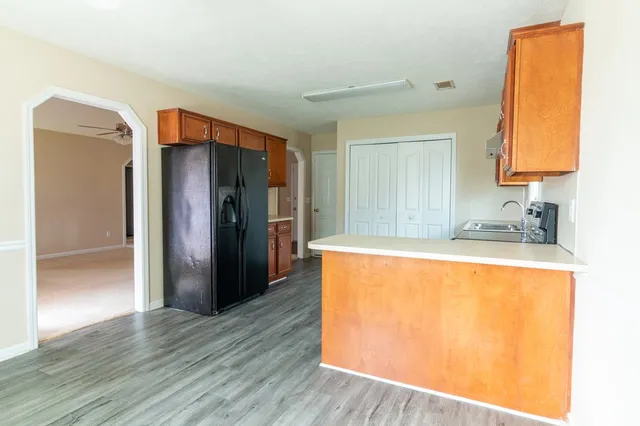 a kitchen with stainless steel appliances a refrigerator and a sink