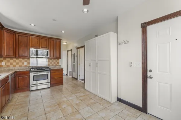 a large kitchen with cabinets and stainless steel appliances