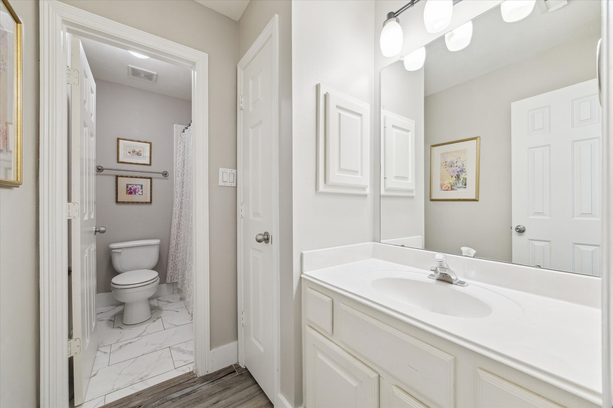5242 Eigel Street Houston, TX 77007 - Photo 22 of 30 a bathroom with a sink a toilet and a mirror