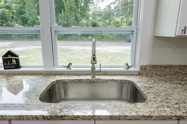 a view of a kitchen sink vanity and outdoor space