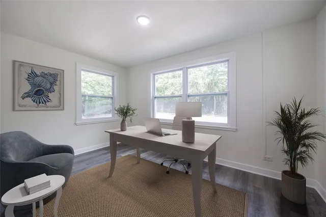 a workspace with furniture and a potted plant