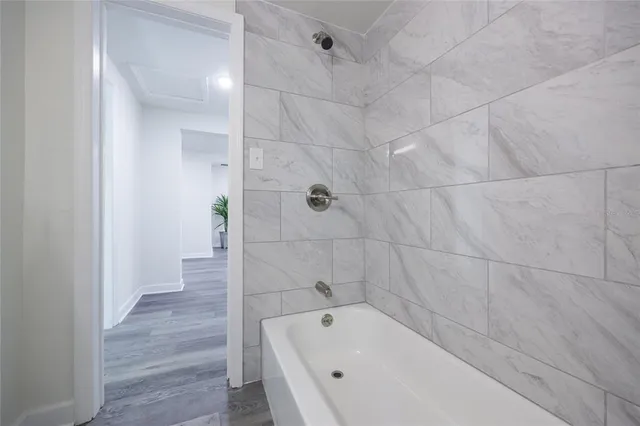 a bathroom with a bathtub and shower