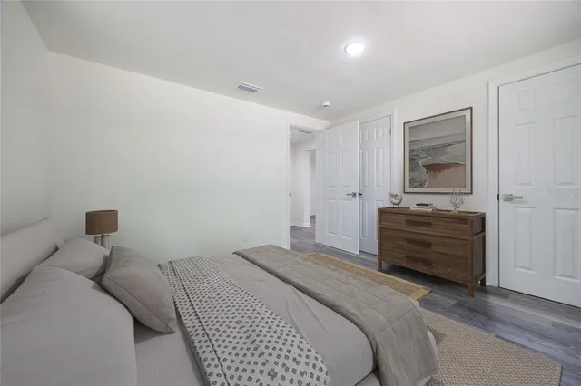 a bedroom with a bed and a view of dresser