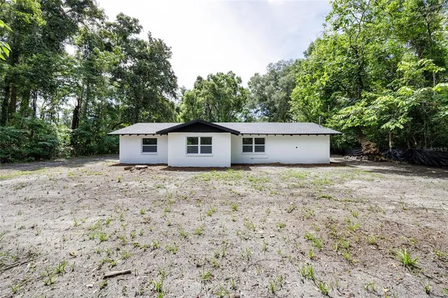 a front view of house with yard and trees