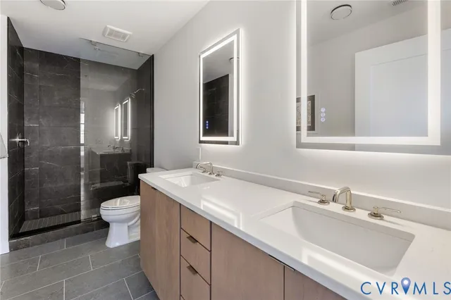 a bathroom with a sink toilet and shower