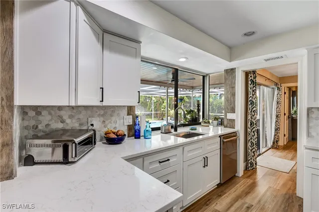 a kitchen with a sink stove and cabinets