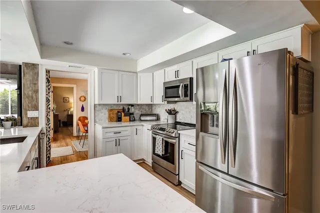 a kitchen with a refrigerator a stove top oven a sink and dishwasher
