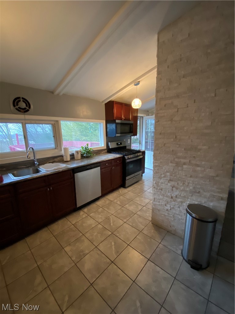 19801 Upper Terrace Road Euclid, OH 44117 - Photo 17 of 22 Kitchen with dishwashing machine, sink, pendant lighting, gas stove, and vaulted ceiling with beams