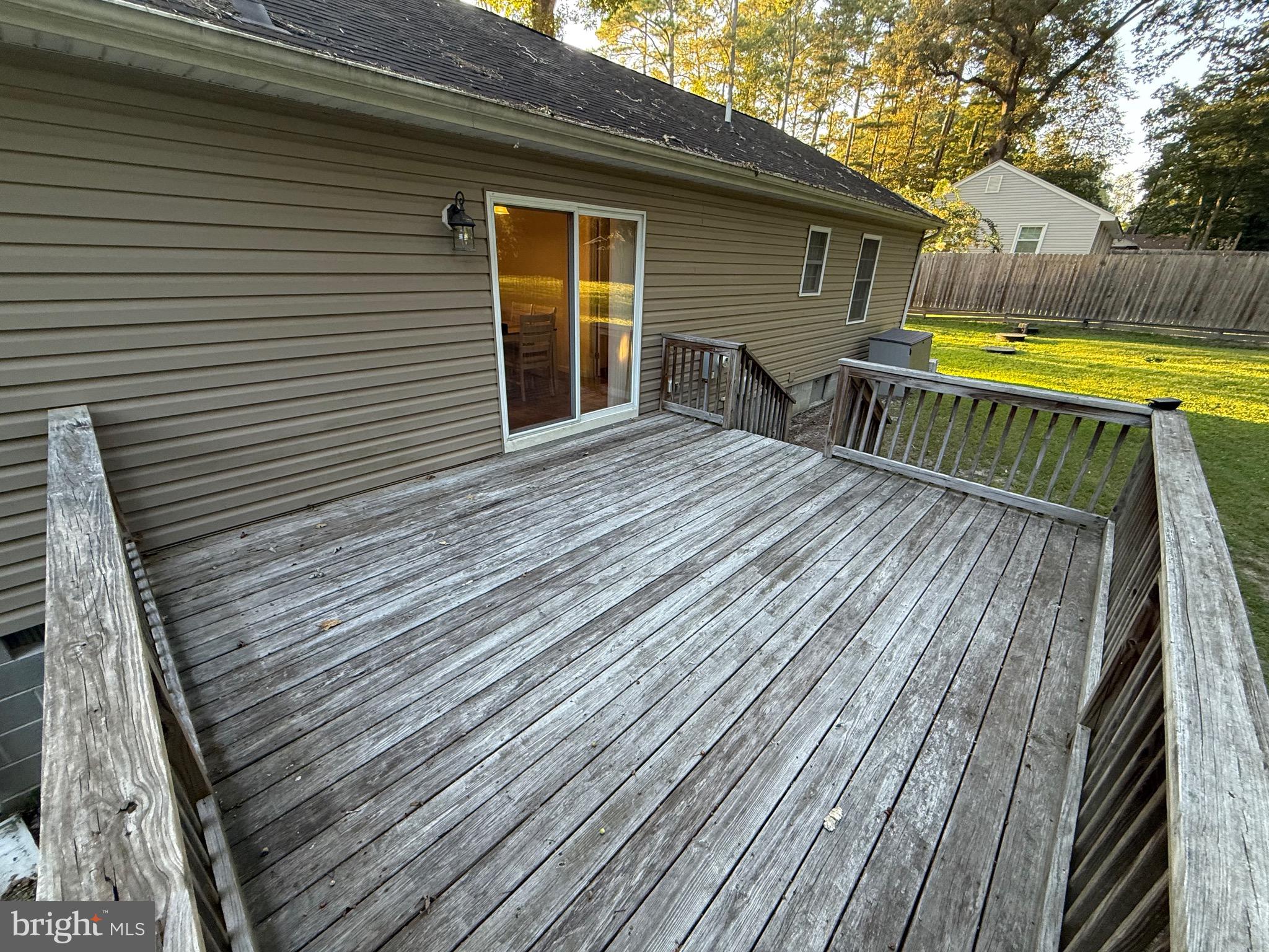 6209 Rockawalkin Road Salisbury, MD 21801 - Photo 17 of 37 a view of a roof deck with wooden floor and fence next to a yard