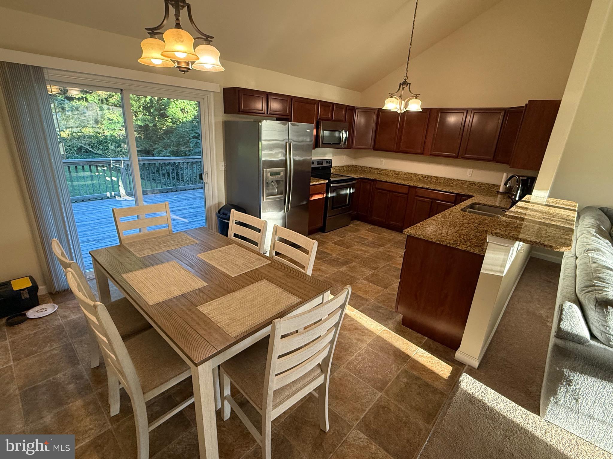 6209 Rockawalkin Road Salisbury, MD 21801 - Photo 22 of 37 a view of a dining room with furniture wooden floor and chandelier