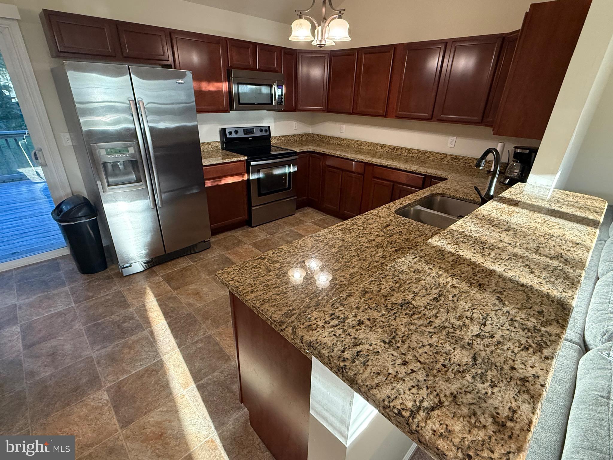 6209 Rockawalkin Road Salisbury, MD 21801 - Photo 23 of 37 a kitchen with stainless steel appliances granite countertop a refrigerator and a sink