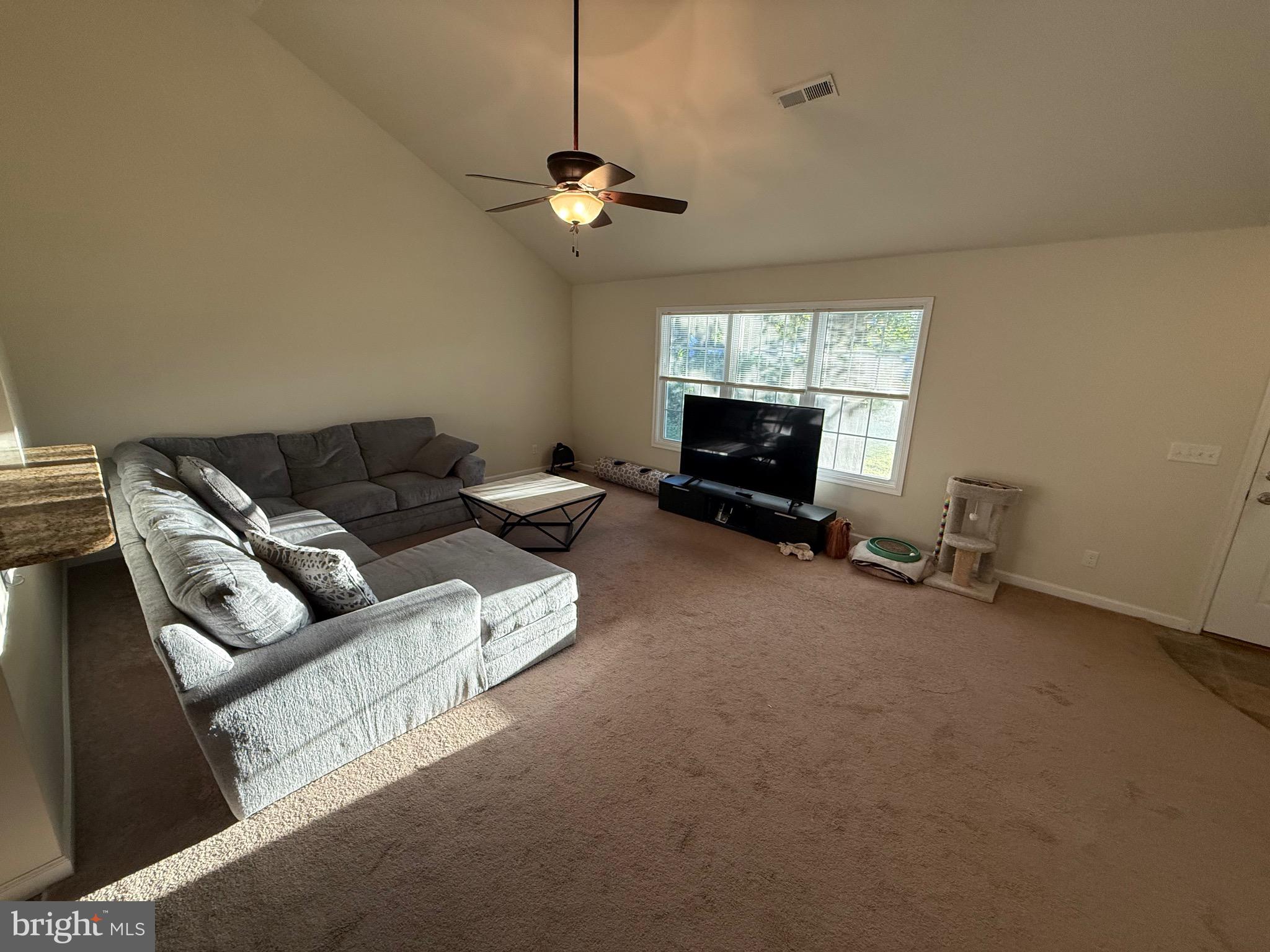6209 Rockawalkin Road Salisbury, MD 21801 - Photo 25 of 37 a living room with furniture ceiling fan and a window