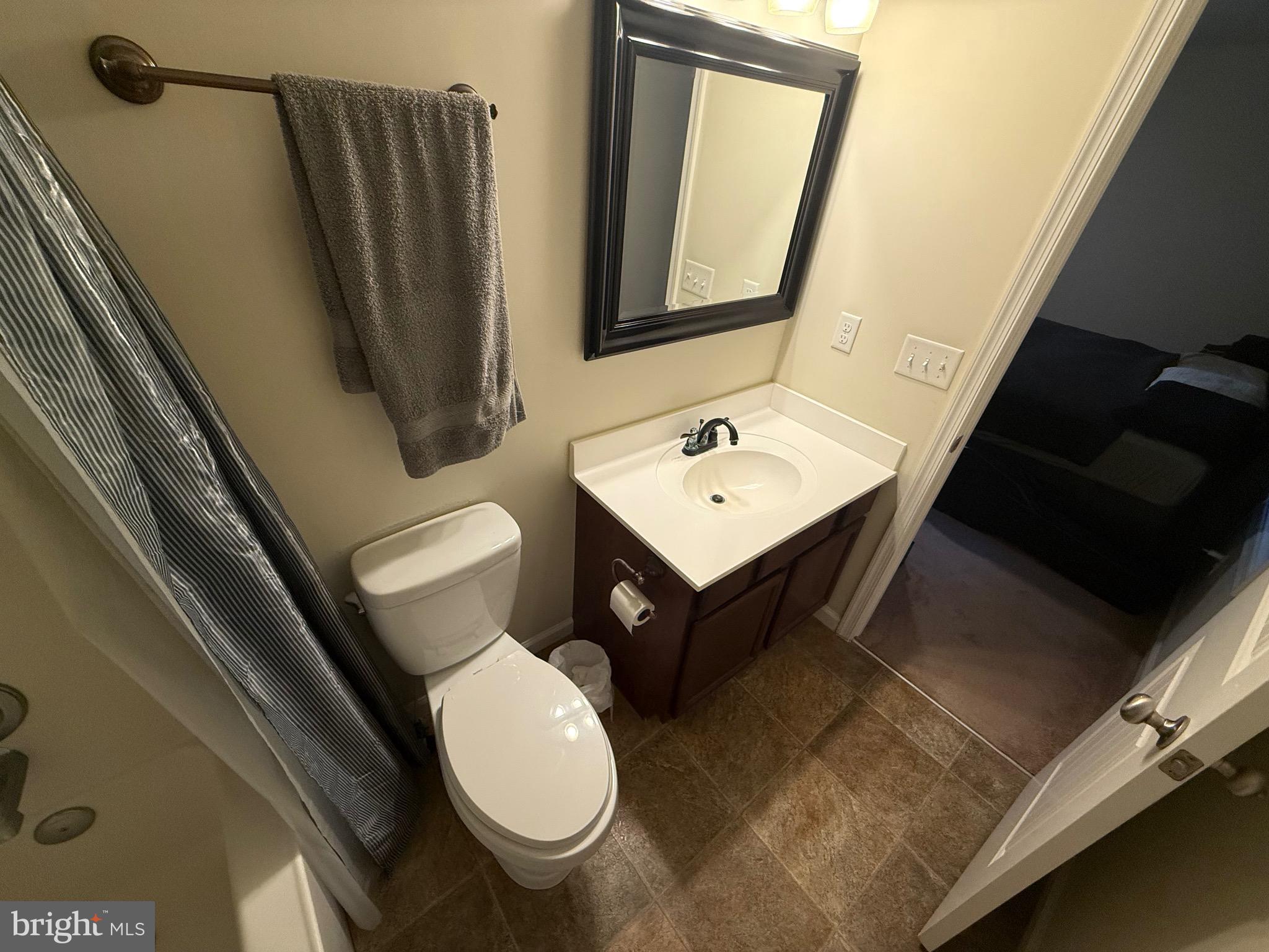 6209 Rockawalkin Road Salisbury, MD 21801 - Photo 29 of 37 a bathroom with a toilet sink and mirror