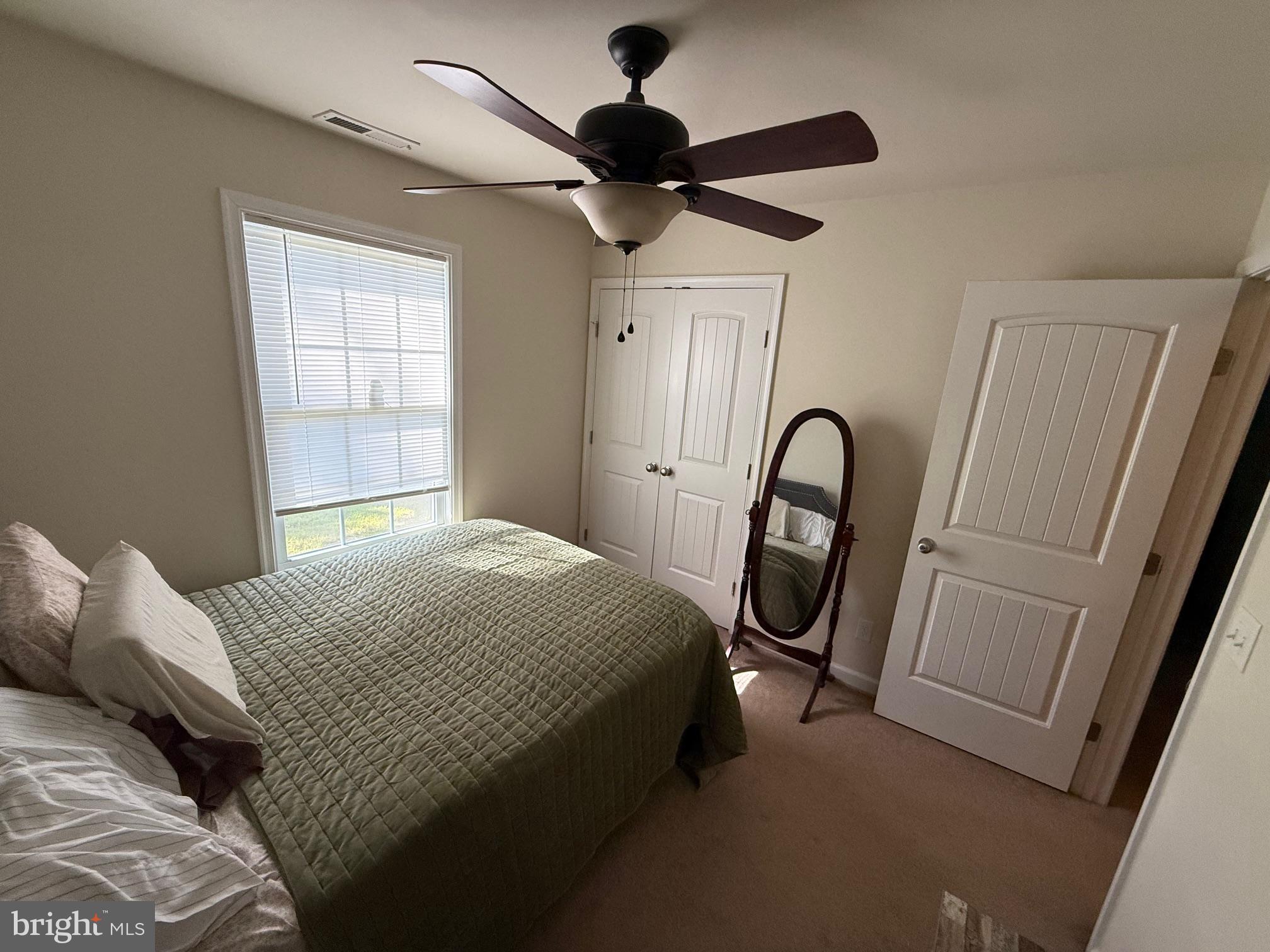 6209 Rockawalkin Road Salisbury, MD 21801 - Photo 31 of 37 a bedroom with a bed and a mirror