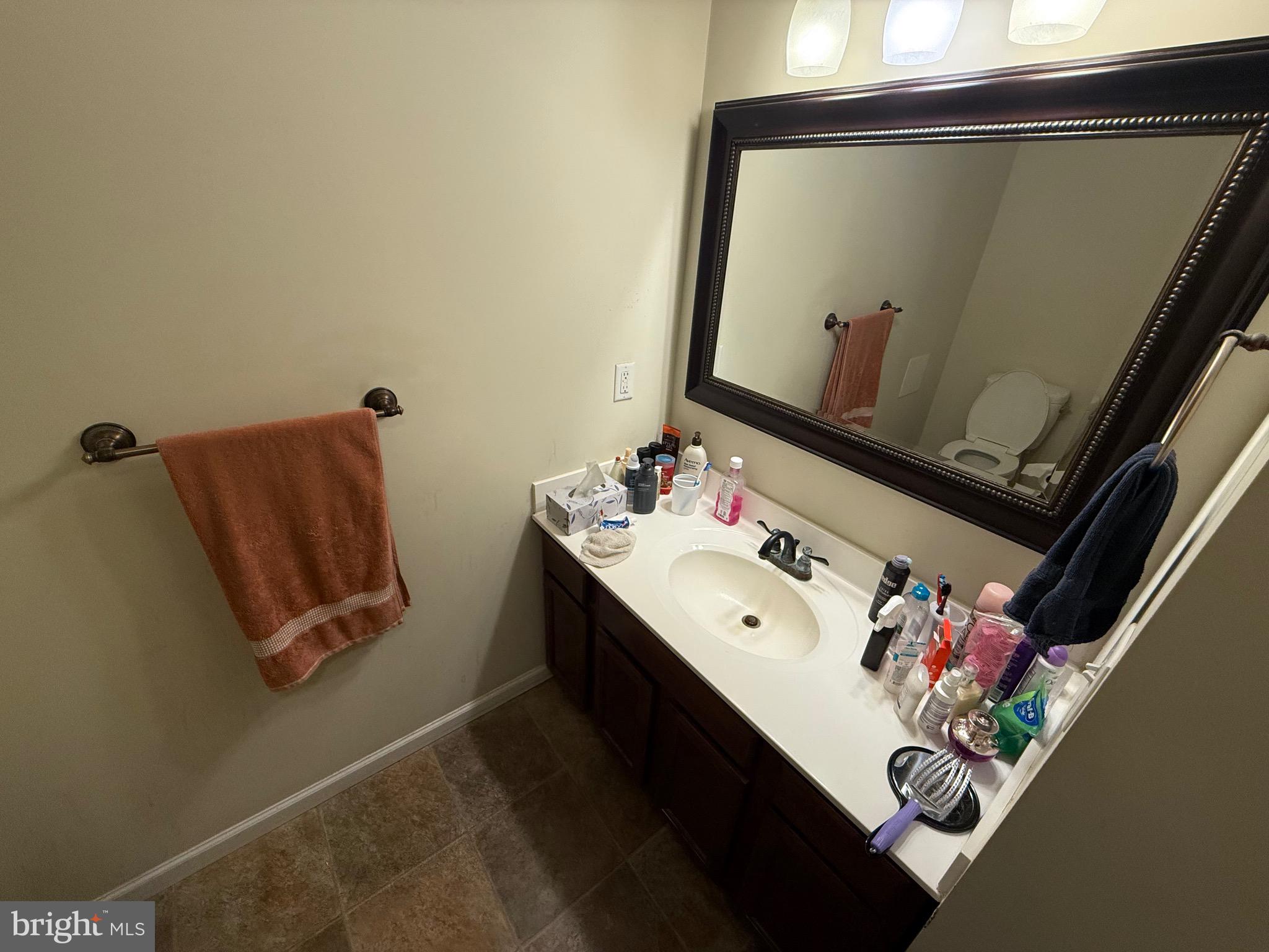 6209 Rockawalkin Road Salisbury, MD 21801 - Photo 35 of 37 a bathroom with a sink mirror and vanity