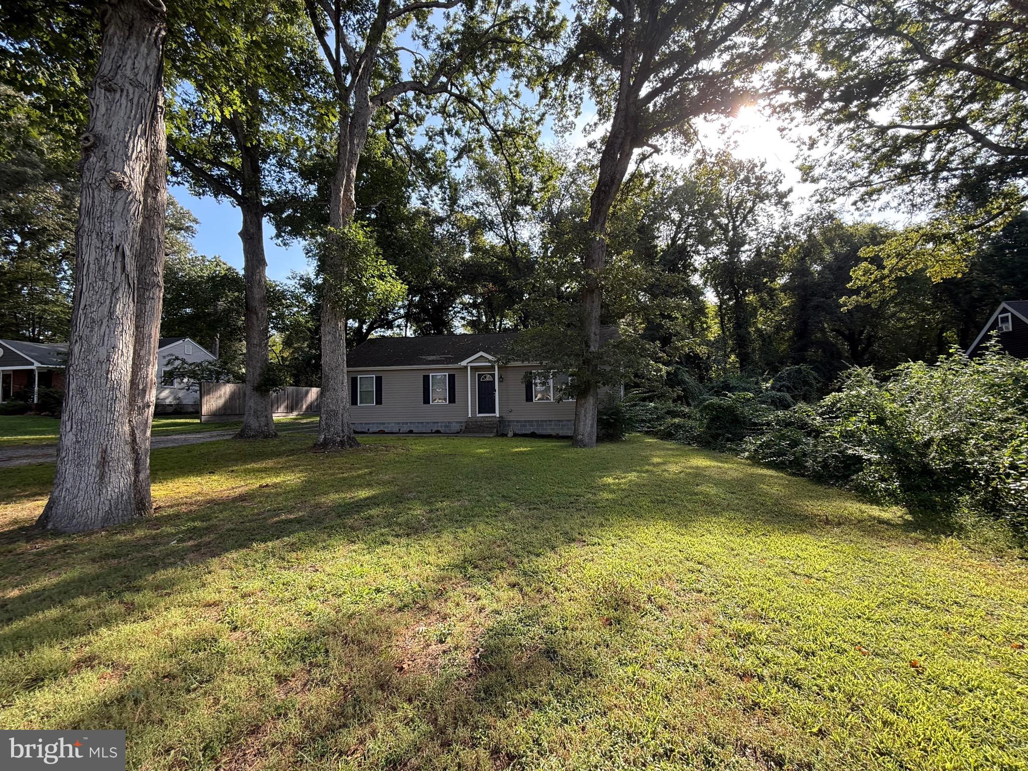 6209 Rockawalkin Road Salisbury, MD 21801 - Photo 5 of 37 a view of a swimming pool with lawn chairs under an umbrella