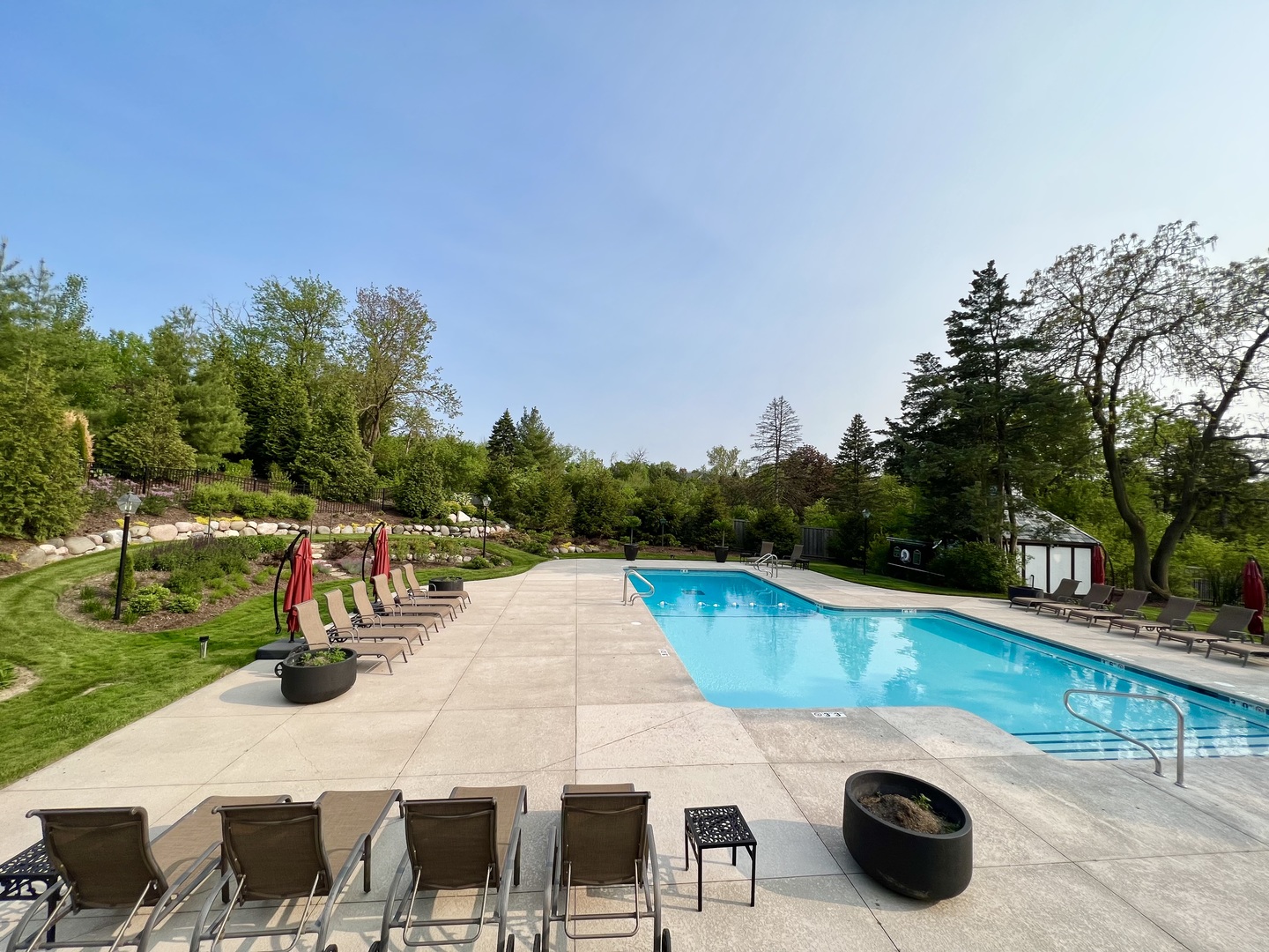 104 Burr Ridge Club Burr Ridge, IL 60527 - Photo 28 of 32 a view of a swimming pool and lounge chairs