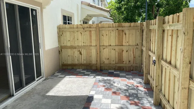 a view of a house with a wooden fence
