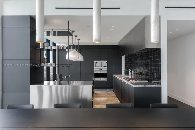 a open kitchen with stainless steel appliances granite countertop a sink and a refrigerator