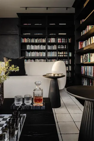 a bedroom with a bed large windows and wooden floor