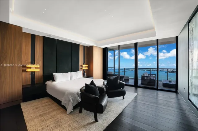 a bedroom with a large bed and a large window