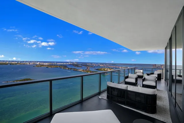 a bedroom with a bed a bookshelf and a flat screen tv