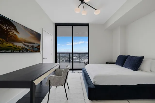 a view of a balcony with furniture and a potted plant
