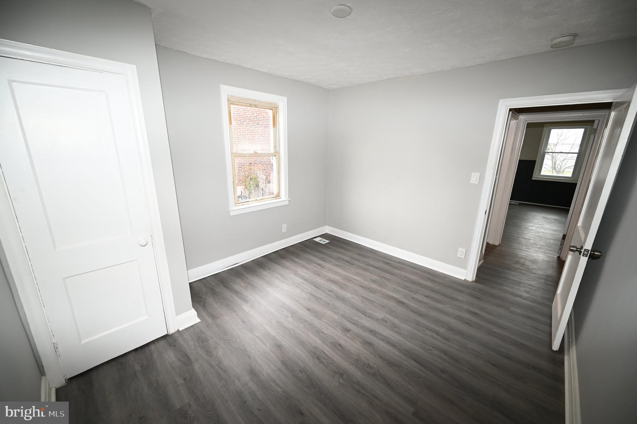 2952 Sollers Point Road, Unit B Dundalk, MD 21222 - Photo 18 of 37 an empty room with wooden floor and windows
