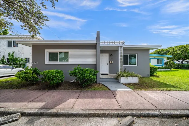 a front view of a house with garden and porch