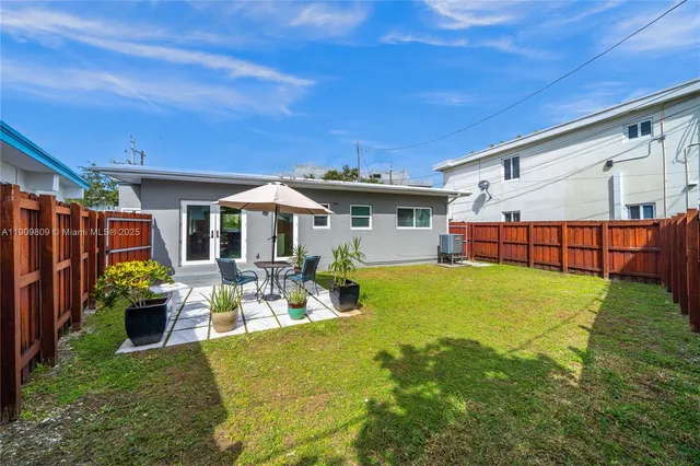 a front view of house with outdoor seating and yard