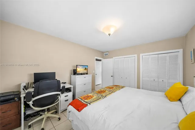 a bedroom with a bed and gym equipment