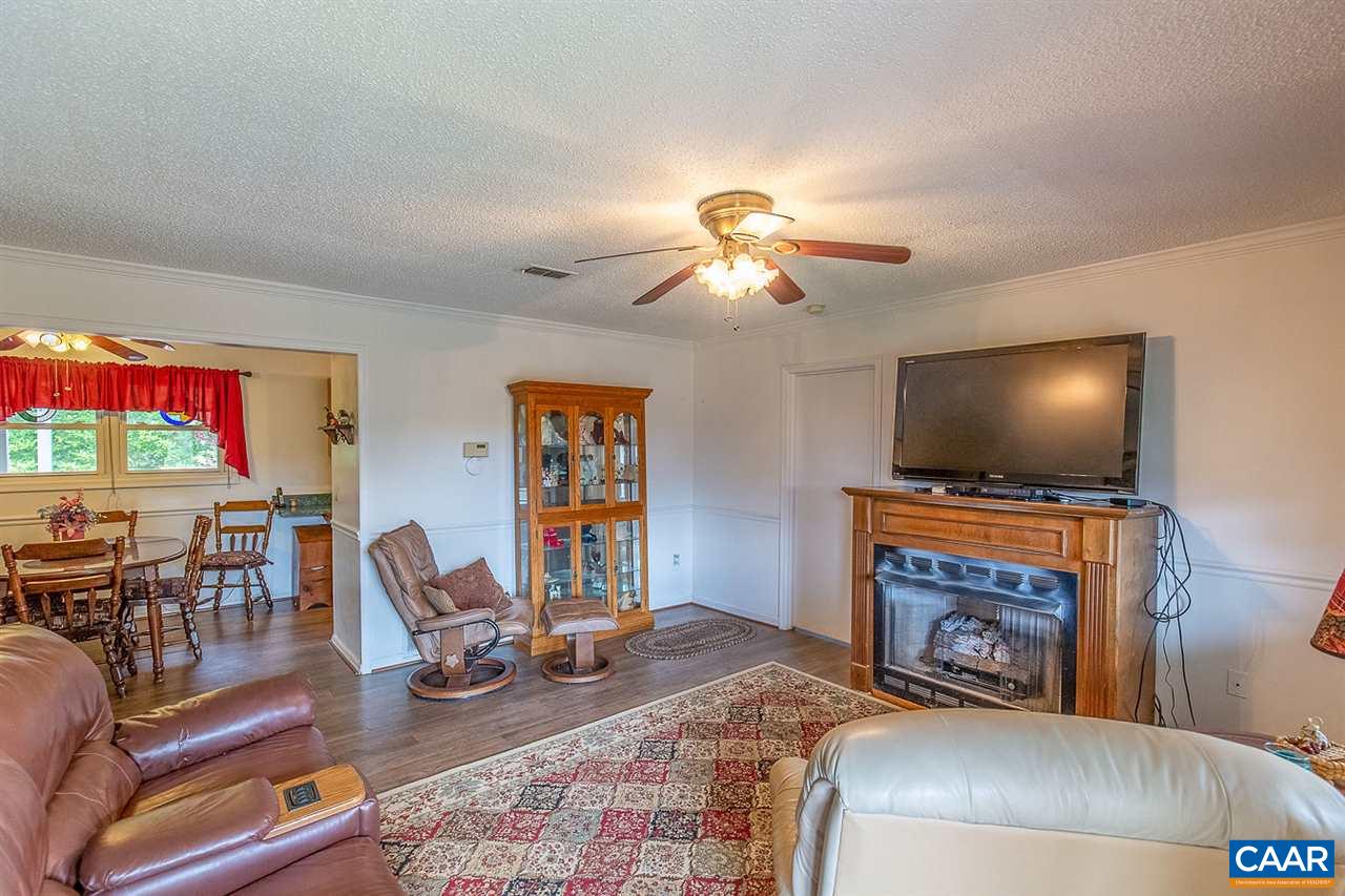 52 Morning Glory Road Ruckersville, VA 22968 - Photo 20 of 38 a living room with furniture a flat screen tv and a fireplace