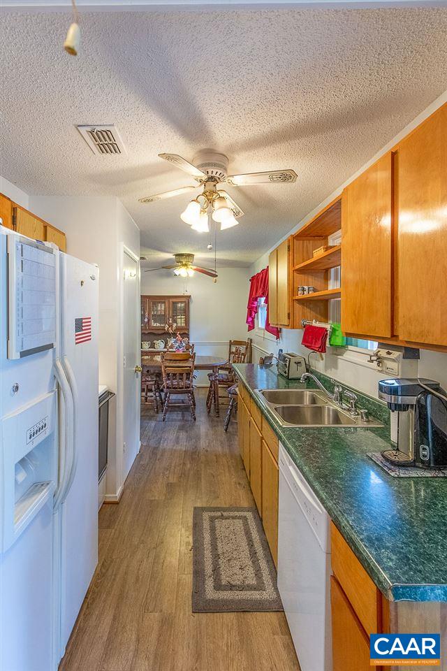 52 Morning Glory Road Ruckersville, VA 22968 - Photo 29 of 38 a kitchen with stainless steel appliances granite countertop a sink counter space and cabinets