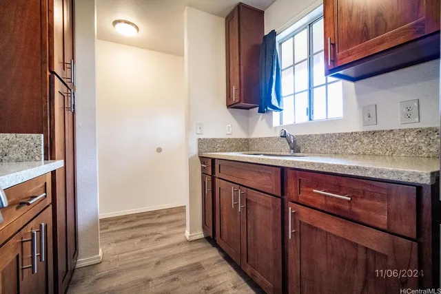 a kitchen with a sink and a refrigerator