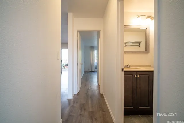a view of a hallway with wooden floor