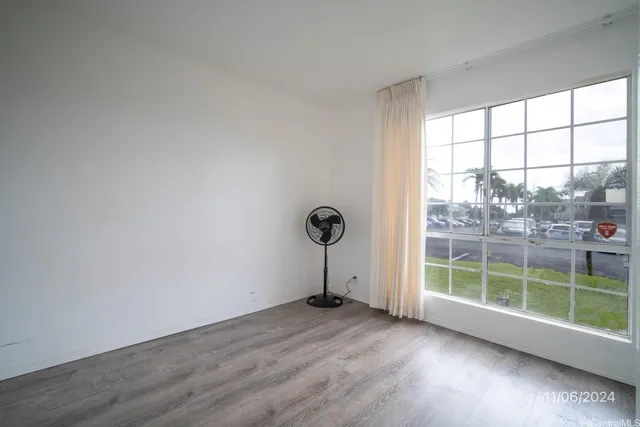 a view of a room with wooden floor and windows