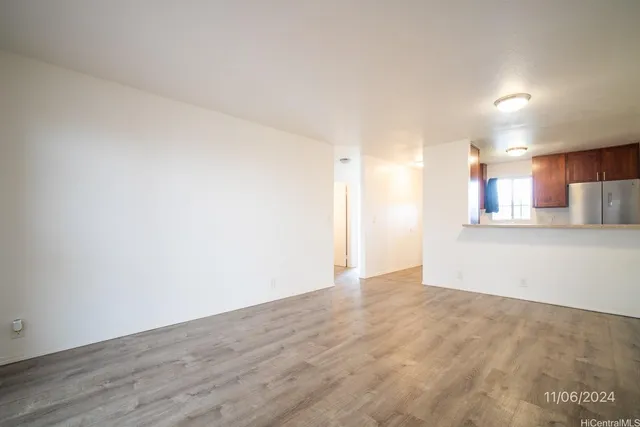 a view of a kitchen with a sink and a refrigerator