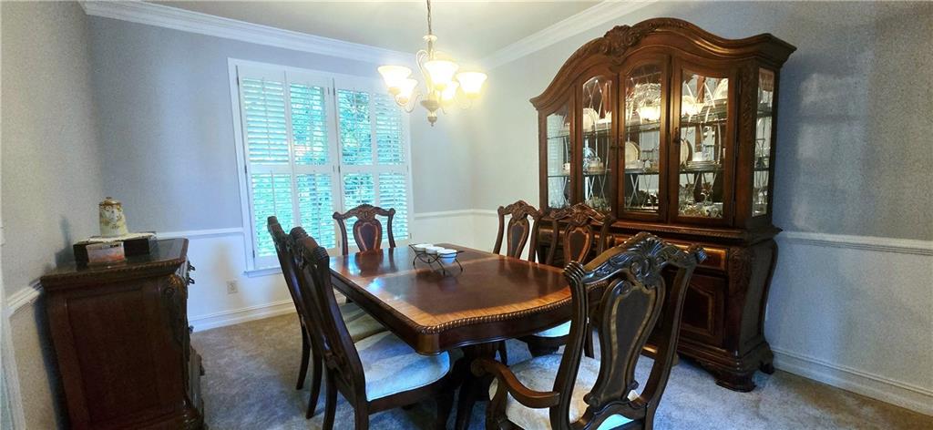 409 Misty Ridge Way Woodstock, GA 30189 - Photo 13 of 20 a view of a dining room with furniture and window