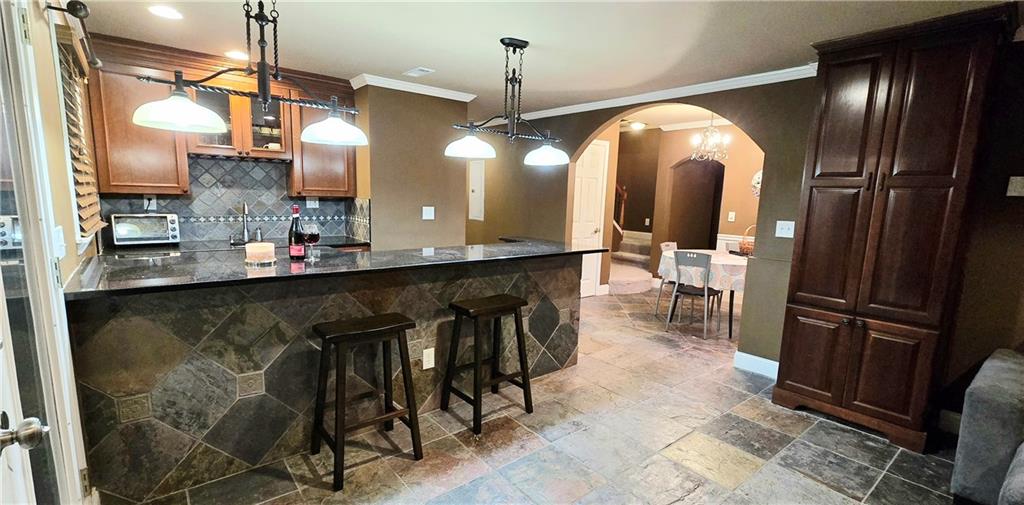 409 Misty Ridge Way Woodstock, GA 30189 - Photo 14 of 20 a kitchen with kitchen island granite countertop a sink appliances and a counter top space