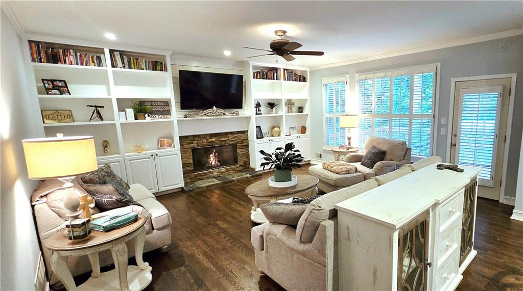 409 Misty Ridge Way Woodstock, GA 30189 - Photo 2 of 20 a living room with fireplace furniture and a flat screen tv