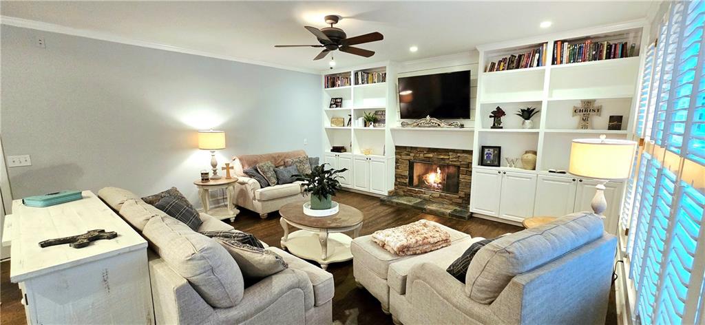 409 Misty Ridge Way Woodstock, GA 30189 - Photo 4 of 20 a living room with furniture a fireplace and a flat screen tv