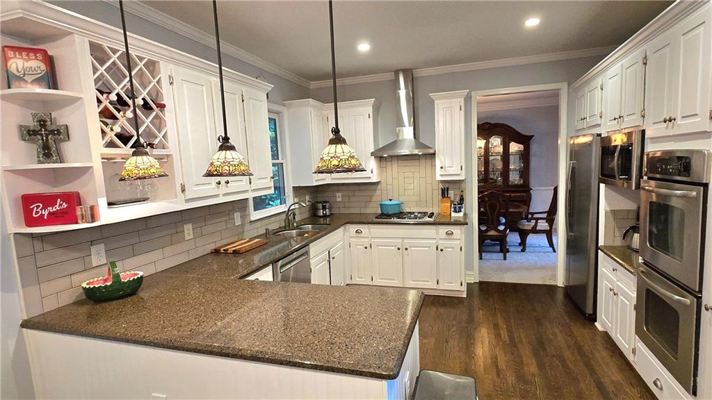 409 Misty Ridge Way Woodstock, GA 30189 - Photo 7 of 20 a kitchen with stainless steel appliances granite countertop a refrigerator a stove and a sink