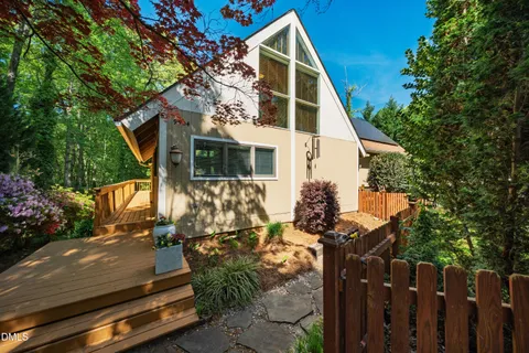 a view of a house with a tree in the background