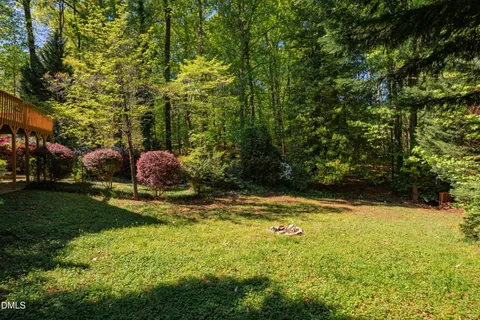 a kitchen with stainless steel appliances granite countertop wooden floor and a sink